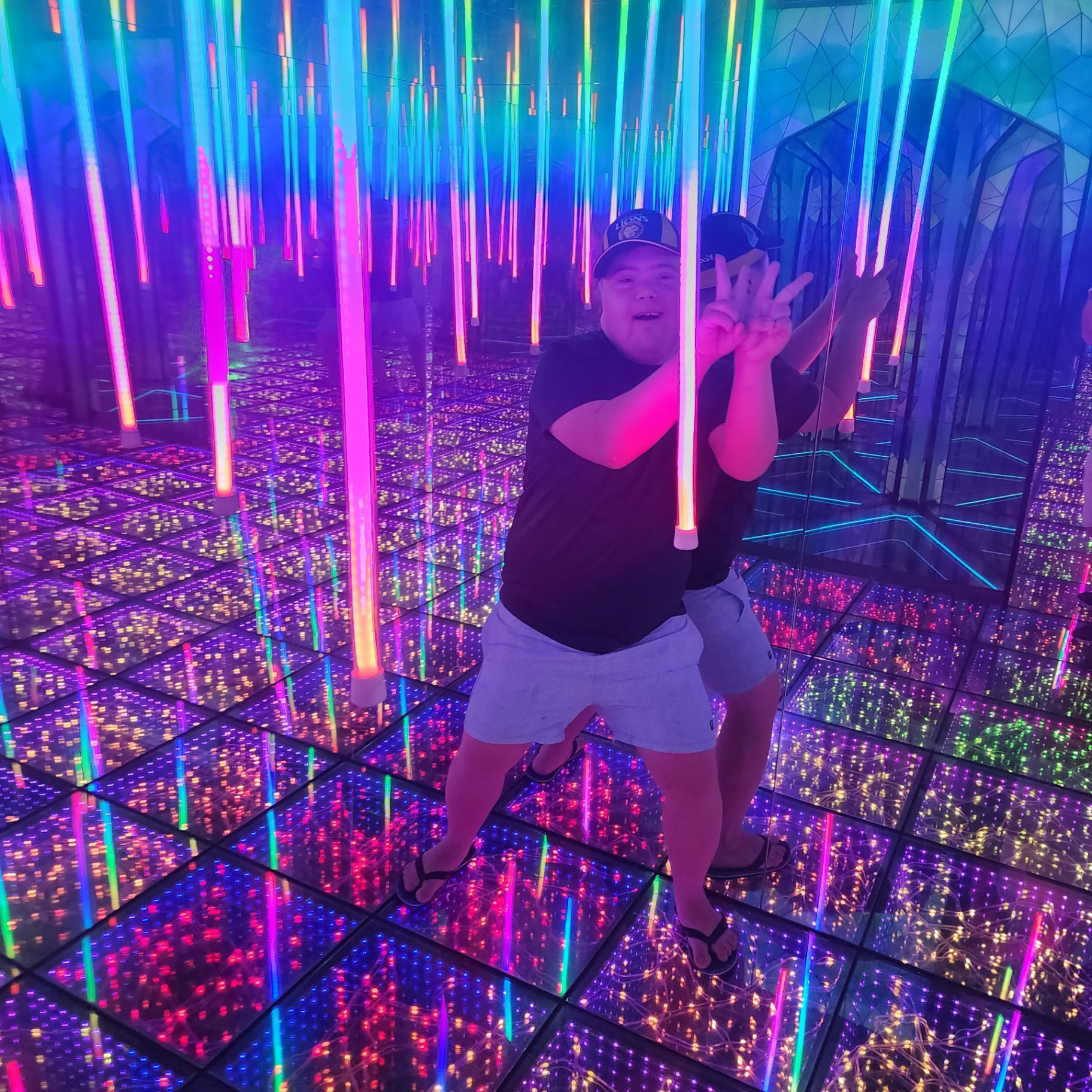 Participant enjoying a vibrant sensory light room experience